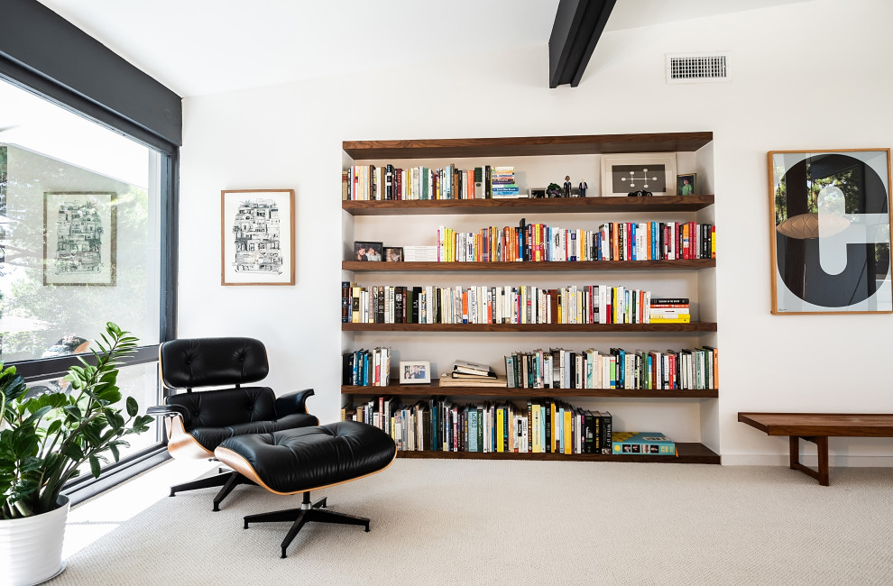 Contemporary open concept living room in Los Angeles with a library, white walls, carpet, beige floor, exposed beam and vaulted.