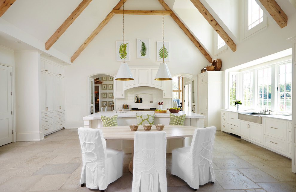 Inspiration for a beach style eat-in kitchen in Birmingham with a farmhouse sink, shaker cabinets, white cabinets, white splashback and with island.