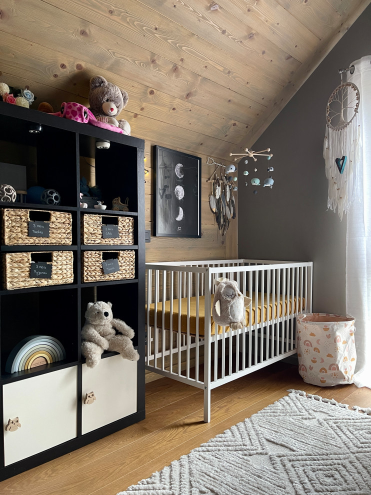 Design ideas for a medium sized world-inspired nursery for girls in Lyon with beige walls, dark hardwood flooring, brown floors, a wood ceiling and wallpapered walls.