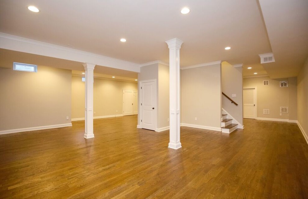 Inspiration for a large transitional look-out basement in New York with medium hardwood floors, beige walls and no fireplace.