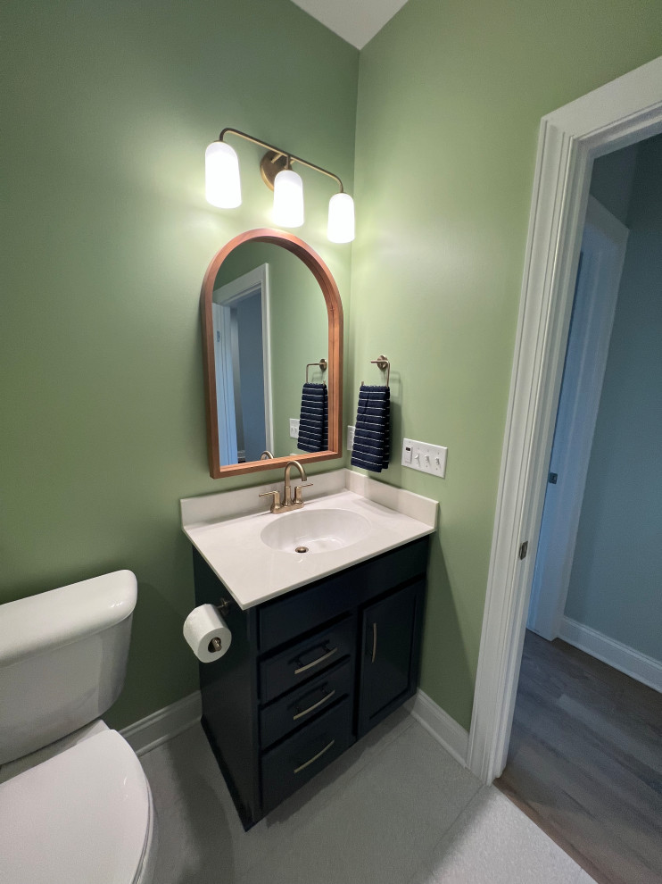 Photo of a small modern family bathroom in New York with flat-panel cabinets, dark wood cabinets, green walls, ceramic flooring, an integrated sink, laminate worktops, grey floors, white worktops, a single sink and a floating vanity unit.