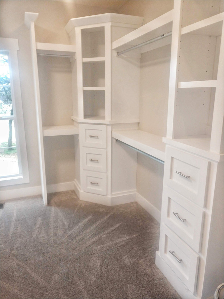 Photo of a country dressing room in Nashville with shaker cabinets, white cabinets, carpet and beige floor.