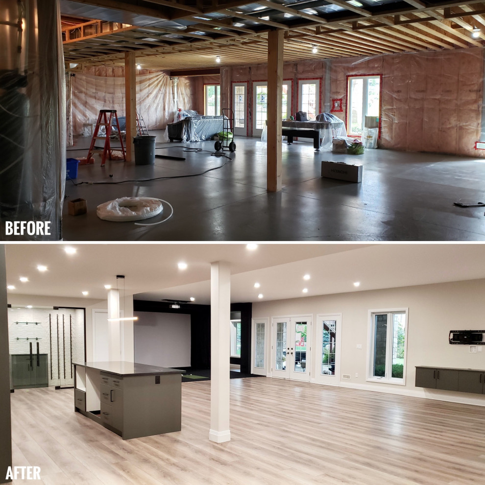 Large transitional walk-out vinyl floor basement photo with a bar and a tile fireplace