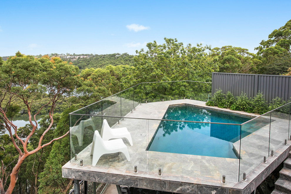 This is an example of a contemporary backyard custom-shaped lap pool in Sydney.