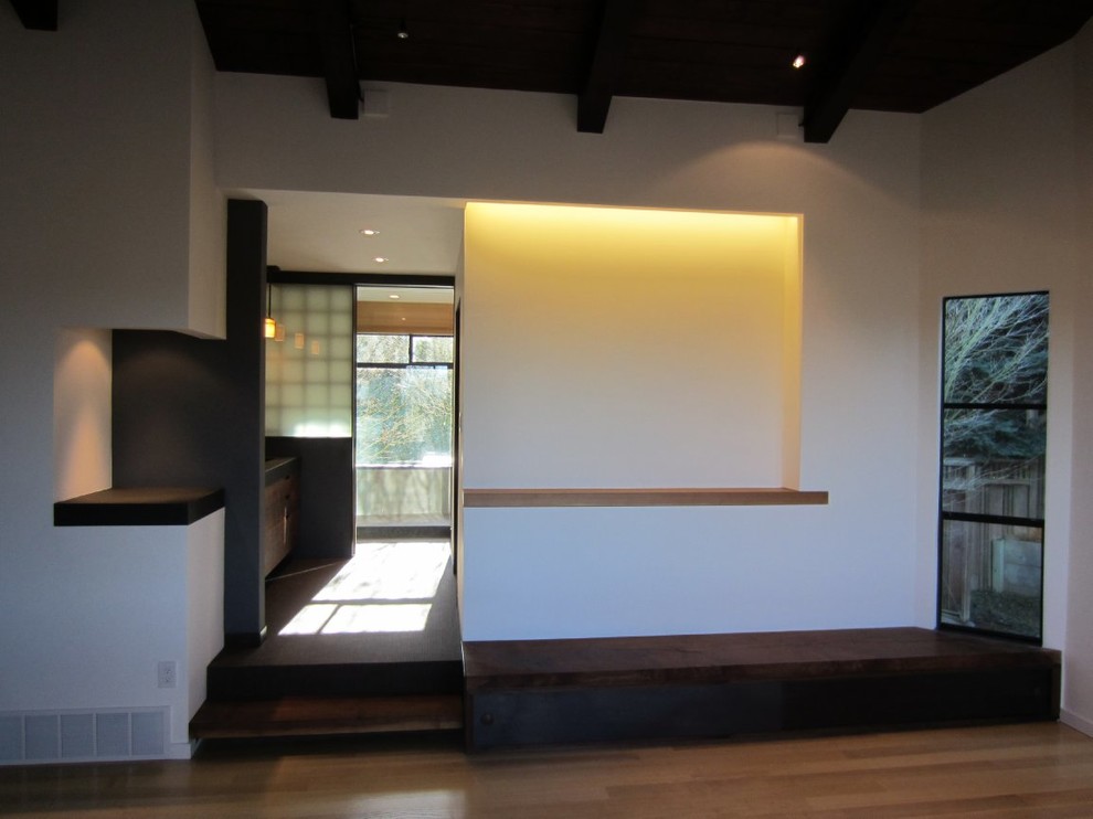 This is an example of a mid-sized asian master bedroom in San Francisco with white walls and light hardwood floors.