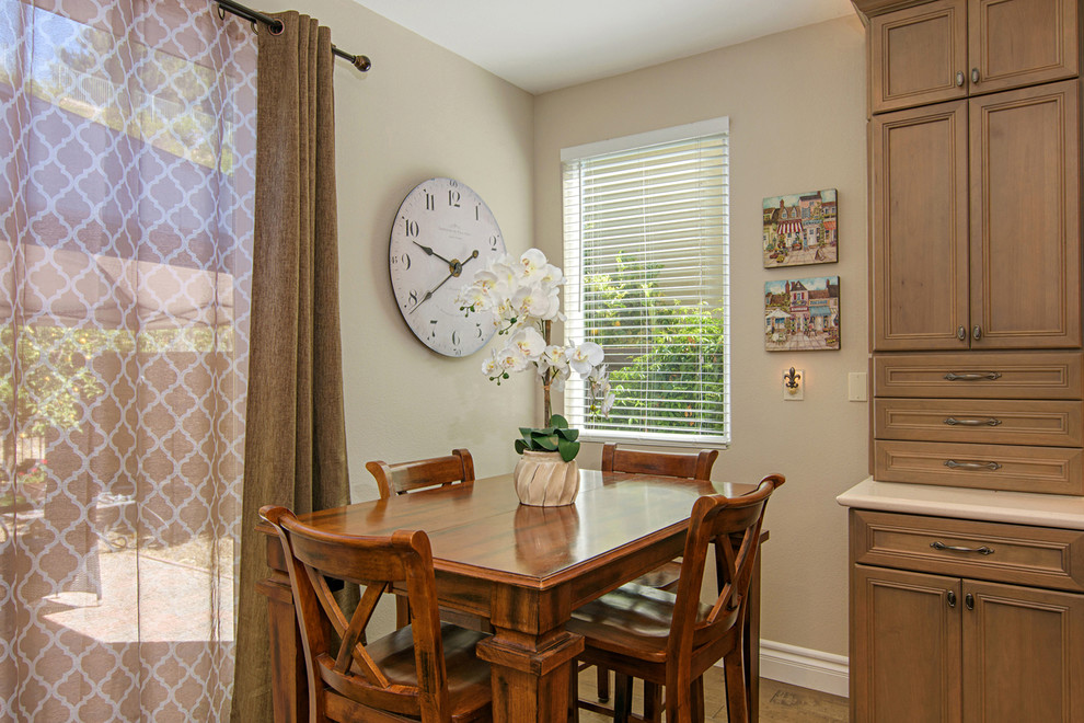 Example of a large transitional l-shaped medium tone wood floor and brown floor open concept kitchen design in San Diego with beige walls, a farmhouse sink, recessed-panel cabinets, medium tone wood cabinets, quartz countertops, beige backsplash, travertine backsplash, paneled appliances and an island