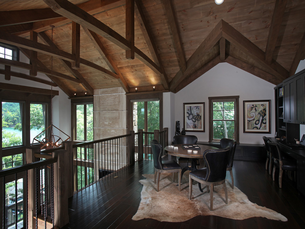 Mid-sized mountain style built-in desk dark wood floor home office photo in Atlanta with white walls