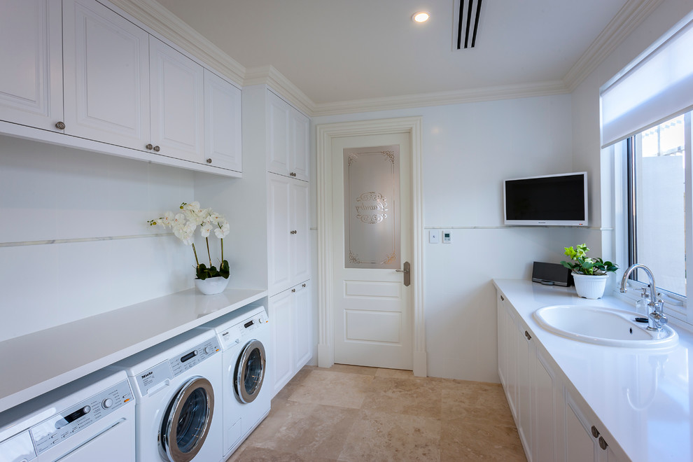 Large traditional galley utility room in Perth with a drop-in sink, shaker cabinets, white cabinets, white walls, a side-by-side washer and dryer, quartz benchtops and travertine floors.