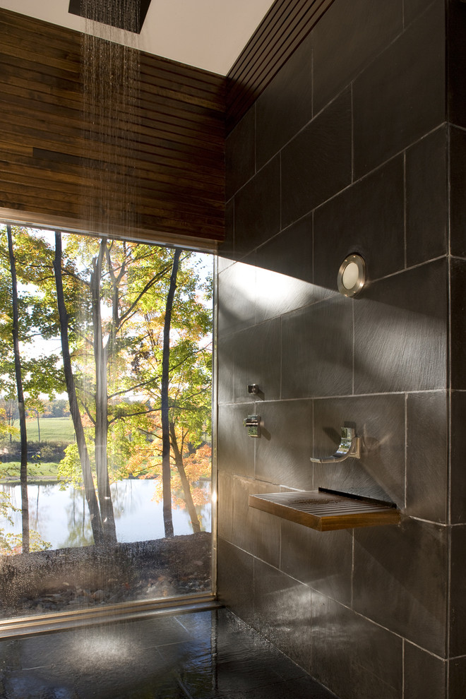 Inspiration for a modern gray tile doorless shower remodel in New York