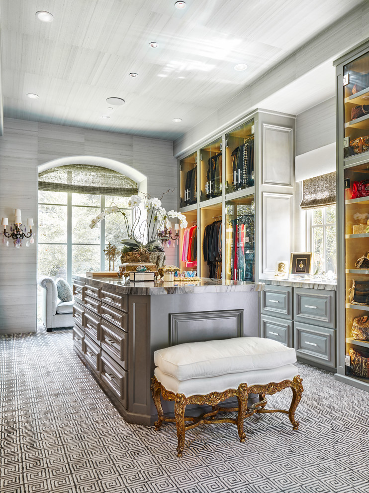 Design ideas for a large traditional women's walk-in wardrobe in Dallas with raised-panel cabinets, grey cabinets and carpet.