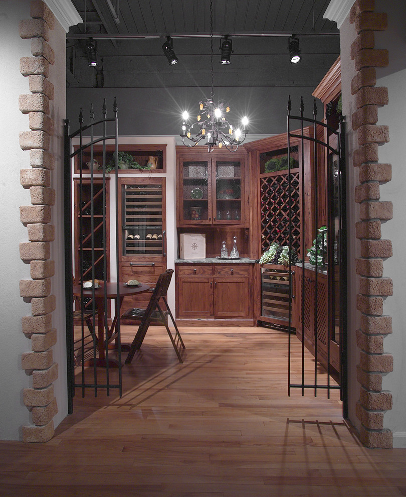 This is an example of a large traditional wine cellar in New York with light hardwood floors and diamond bins.
