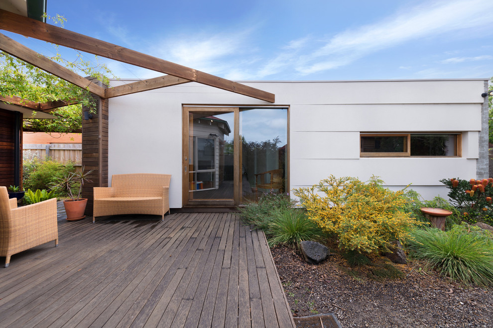 This is an example of a mid-sized contemporary deck in Melbourne with a pergola.