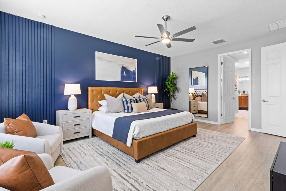 Photo of a large contemporary master bedroom in Orlando with blue walls.