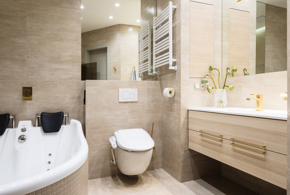 Design ideas for a large contemporary master bathroom in Saint Petersburg with flat-panel cabinets, light wood cabinets, a hot tub, a shower/bathtub combo, a wall-mount toilet, beige tile, porcelain tile, porcelain floors, beige floor and an integrated sink.