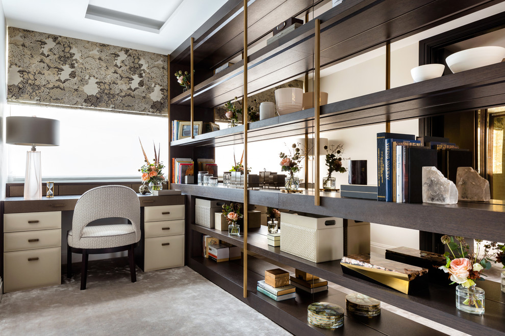 Inspiration for a transitional home office in London with carpet, a built-in desk and beige floor.