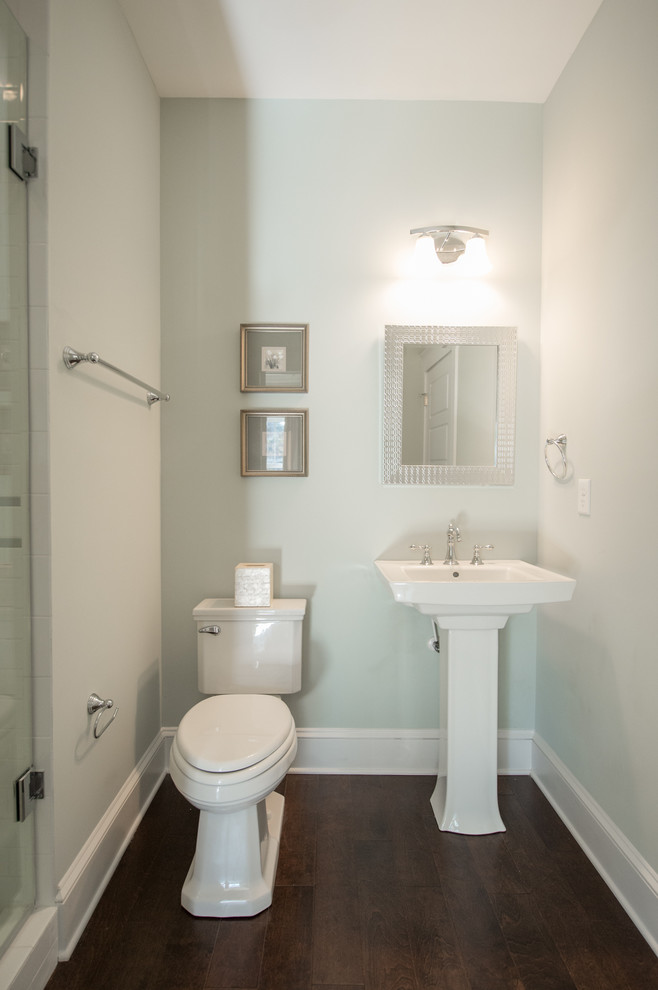 Photo of a traditional bathroom in Jacksonville with an alcove shower, a two-piece toilet, white tile, ceramic tile, grey walls, dark hardwood floors and a pedestal sink.