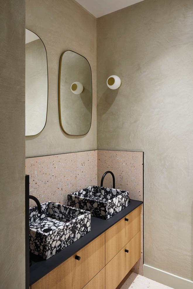 Design ideas for a small contemporary kids bathroom in Paris with brown cabinets, an alcove tub, pink tile, beige walls, ceramic floors, a drop-in sink, solid surface benchtops, beige floor, black benchtops, a double vanity, a floating vanity and flat-panel cabinets.