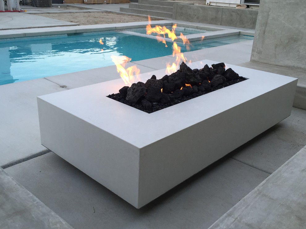 This is an example of a large modern backyard patio in Other with a fire feature.