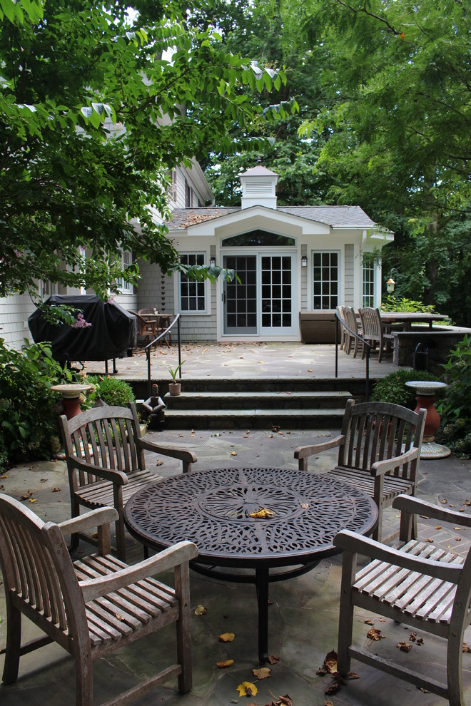 Inspiration for a large traditional backyard patio in New York with natural stone pavers and no cover.
