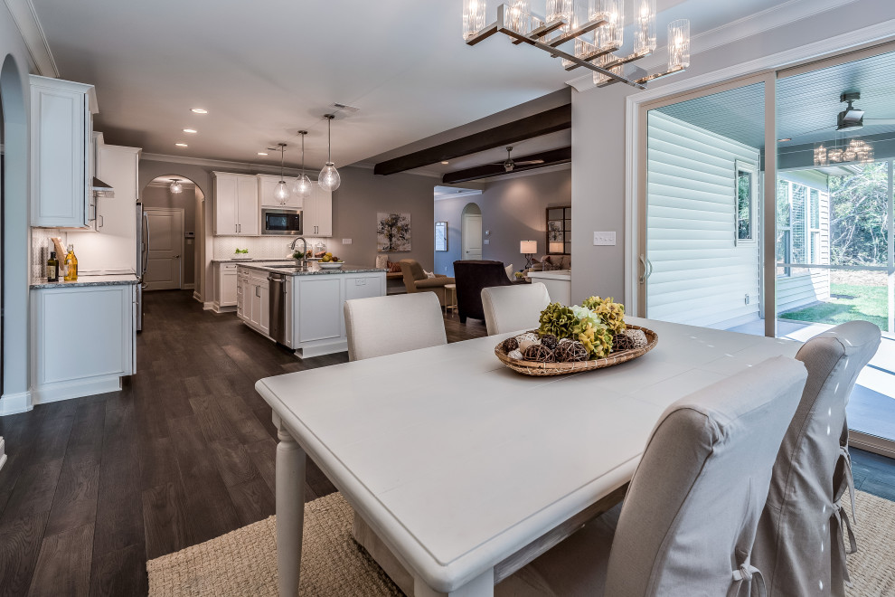Example of a mid-sized transitional l-shaped open concept kitchen design with an undermount sink, flat-panel cabinets, white cabinets, quartz countertops, white backsplash, glass tile backsplash, stainless steel appliances, an island and white countertops
