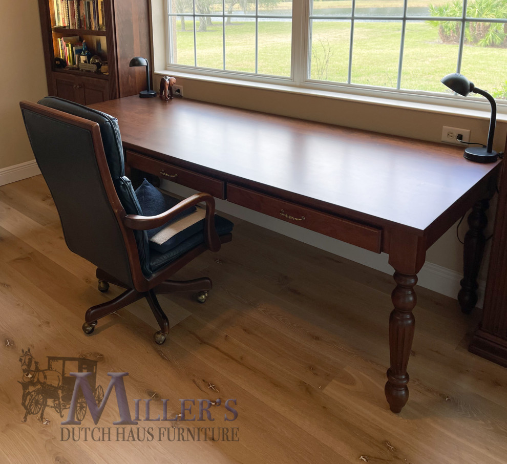 Large traditional home office in Tampa with a library and a freestanding desk.