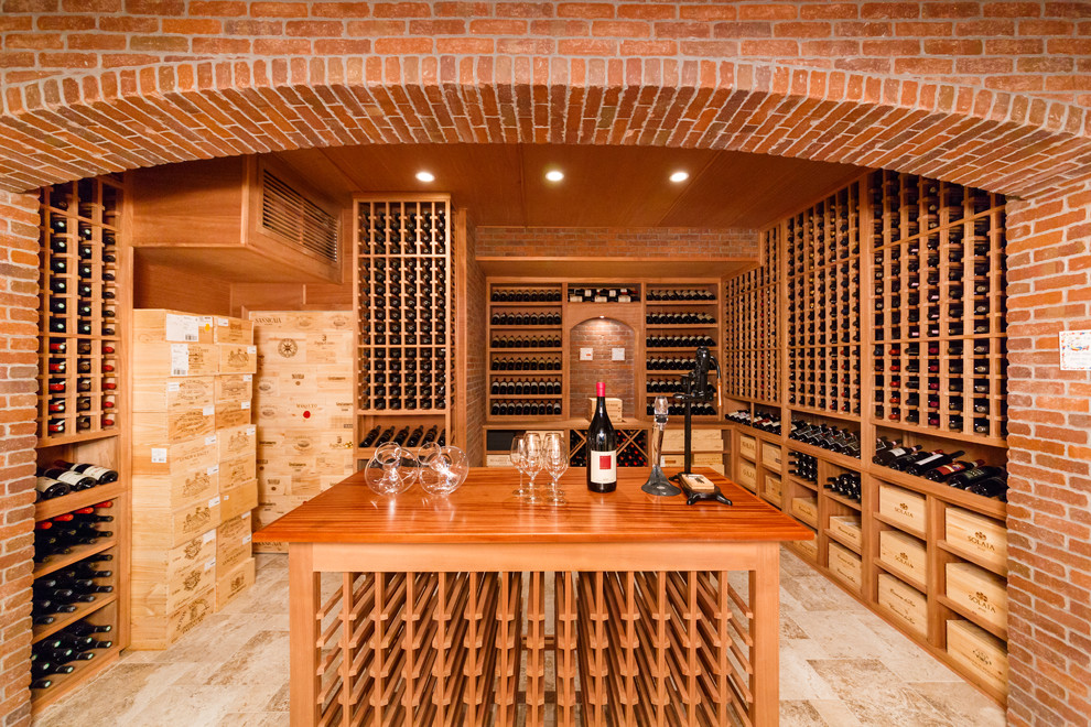 This is an example of a large traditional wine cellar in New York with ceramic floors and storage racks.