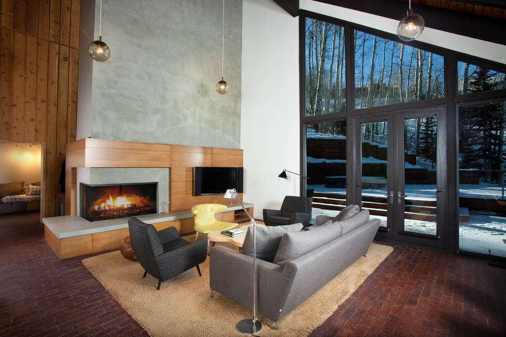 Design ideas for a contemporary formal open concept living room in Denver with white walls, brick floors, a concrete fireplace surround, a wall-mounted tv and a ribbon fireplace.