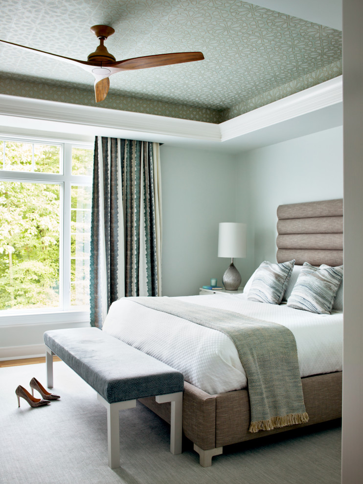 Design ideas for a large transitional master bedroom in New York with green walls and medium hardwood floors.