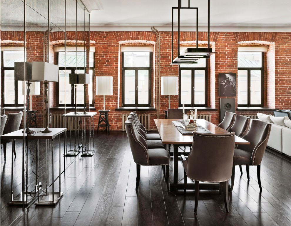 Photo of a large industrial separate dining room in Copenhagen with dark hardwood floors, no fireplace and metallic walls.