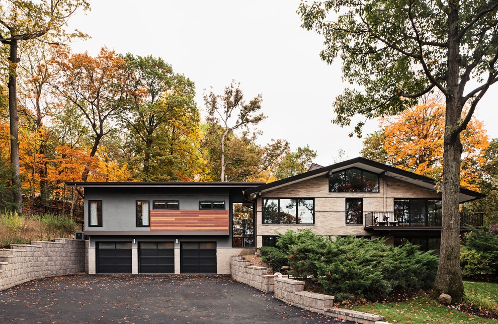 Large 1950s split-level mixed siding house exterior idea in New York with a shed roof
