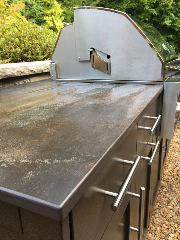 Inspiration for a small craftsman single-wall eat-in kitchen remodel in Raleigh with recessed-panel cabinets, brown cabinets, quartz countertops, stainless steel appliances, no island and multicolored countertops