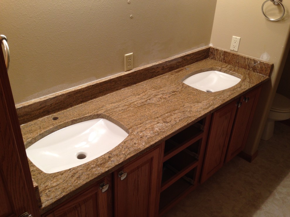 Large transitional bathroom photo with an undermount sink, raised-panel cabinets, medium tone wood cabinets and granite countertops