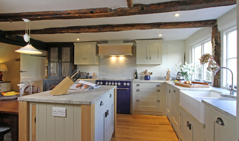 Farmhouse l-shaped kitchen photo in Hampshire with shaker cabinets, beige cabinets, colored appliances and granite countertops