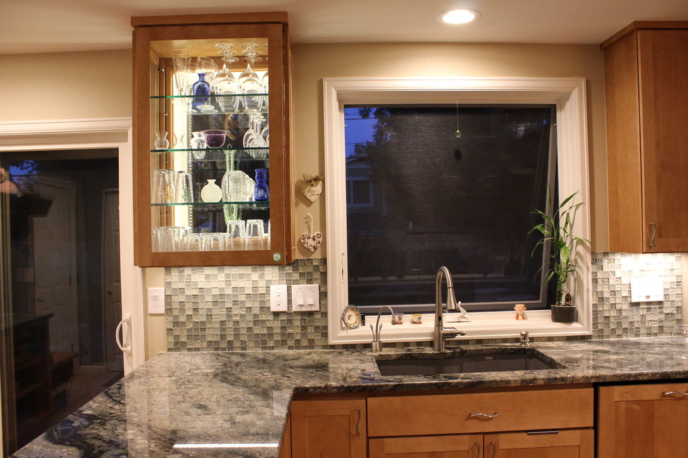 Example of a small transitional light wood floor kitchen design in Denver with an undermount sink, recessed-panel cabinets, light wood cabinets, granite countertops, green backsplash, glass tile backsplash, stainless steel appliances and no island