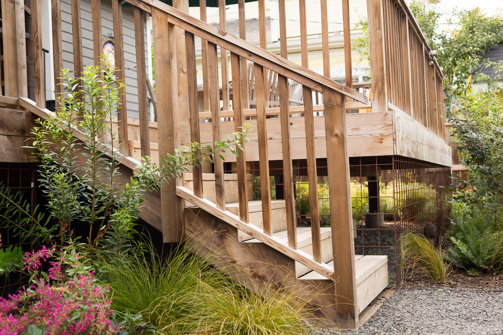 Mid-sized transitional backyard deck photo with a roof extension