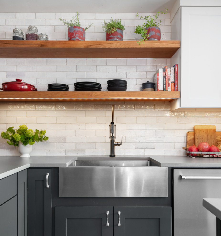 Example of a large transitional l-shaped ceramic tile and gray floor eat-in kitchen design in Austin with a farmhouse sink, shaker cabinets, green cabinets, quartz countertops, yellow backsplash, subway tile backsplash, stainless steel appliances, an island and gray countertops