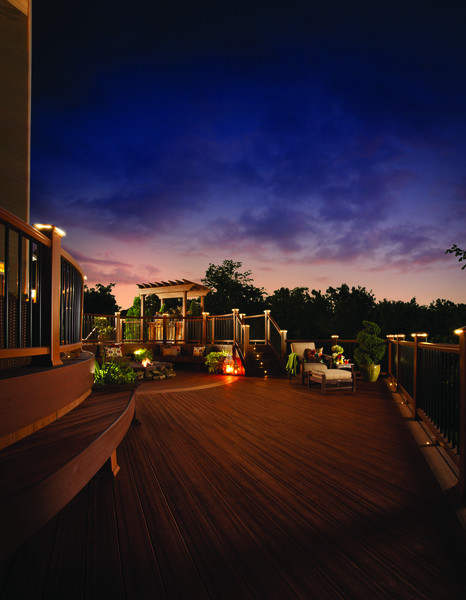 Large elegant backyard deck photo with a fire pit and no cover