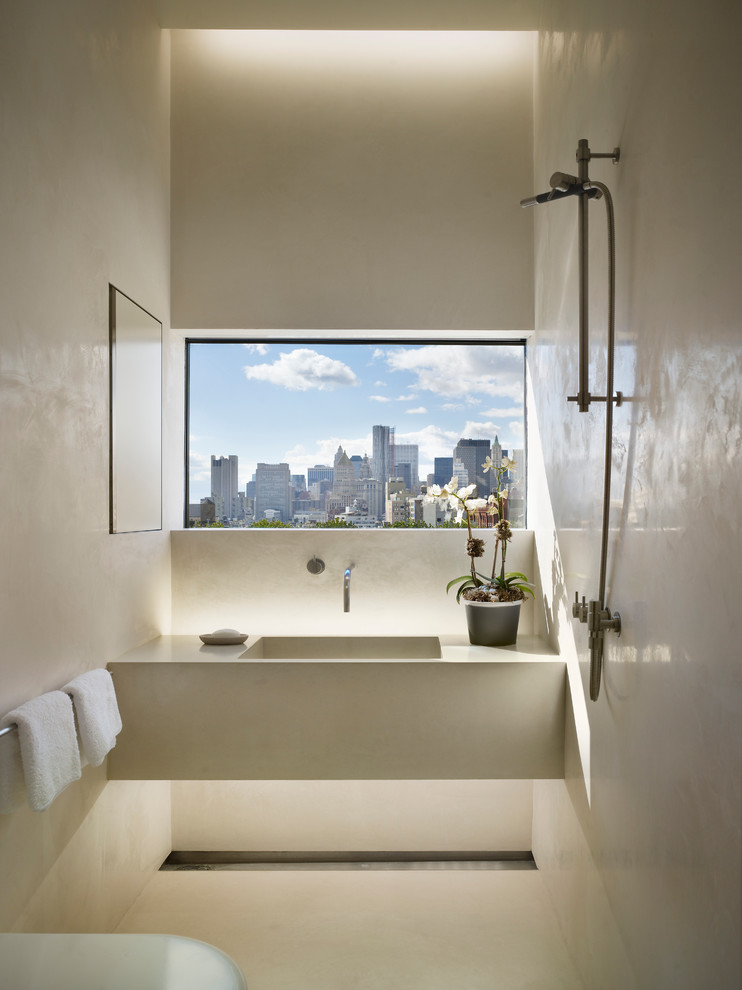 Photo of a contemporary bathroom in New York with an integrated sink and concrete benchtops.