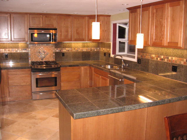 Kitchen - large kitchen idea in Minneapolis with an undermount sink, medium tone wood cabinets, multicolored backsplash, stainless steel appliances and no island