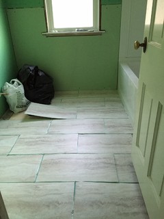 Which direction should I lay the 12x24 vinyl tiles in our bathroom?