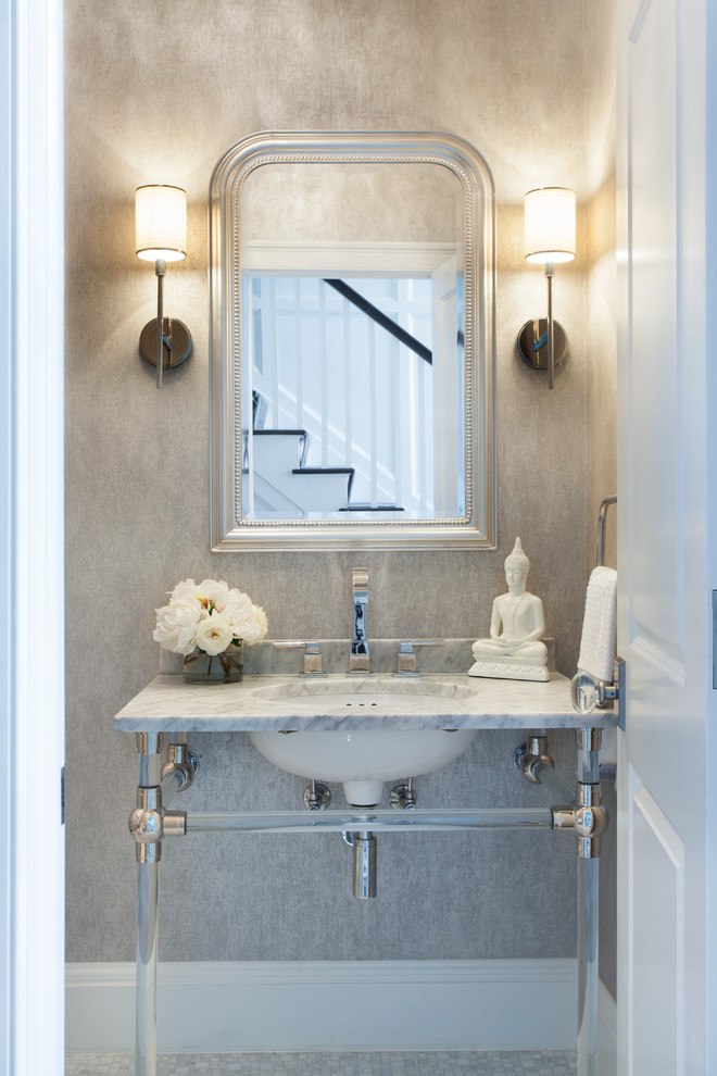 Design ideas for a mid-sized transitional powder room in New York with an undermount sink, grey walls, marble benchtops and grey benchtops.