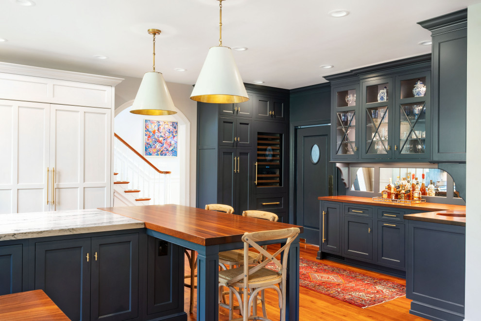 Idee per una cucina con ante blu, top in legno, elettrodomestici da incasso e top marrone