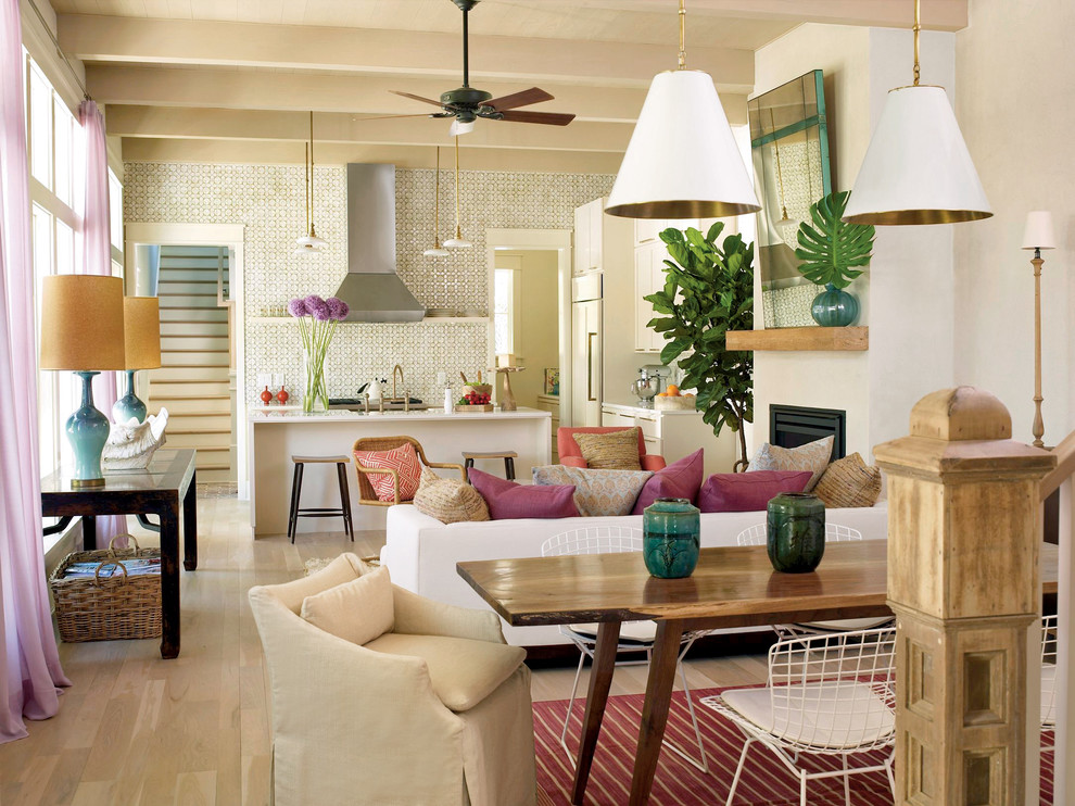 Tropical living room in Charleston with white walls and a standard fireplace.