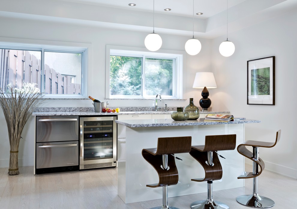 Inspiration for a contemporary kitchen in Montreal with stainless steel appliances, white cabinets and granite benchtops.