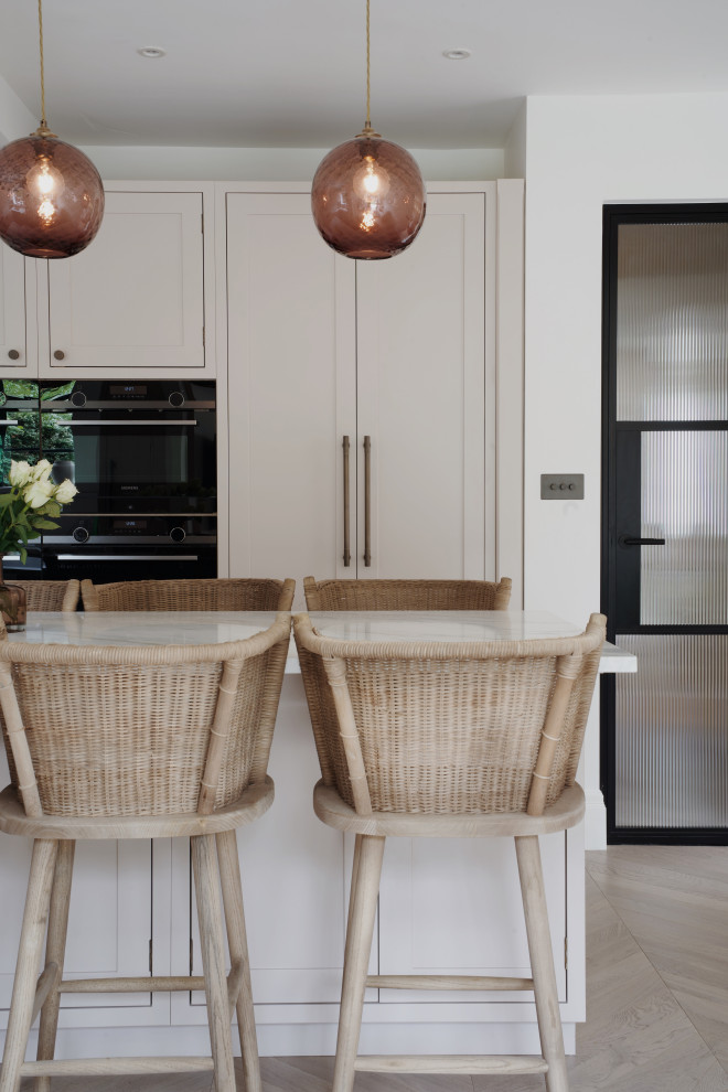 Medium sized classic l-shaped kitchen in London with a submerged sink, shaker cabinets, pink cabinets, quartz worktops, white splashback, an island and white worktops.