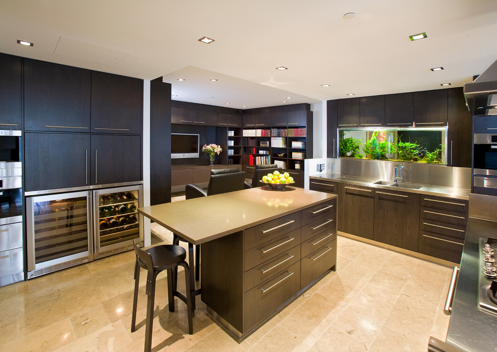 This is an example of a mid-sized contemporary u-shaped separate kitchen in Brisbane with an integrated sink, flat-panel cabinets, dark wood cabinets, quartz benchtops, metallic splashback, stainless steel appliances and limestone floors.
