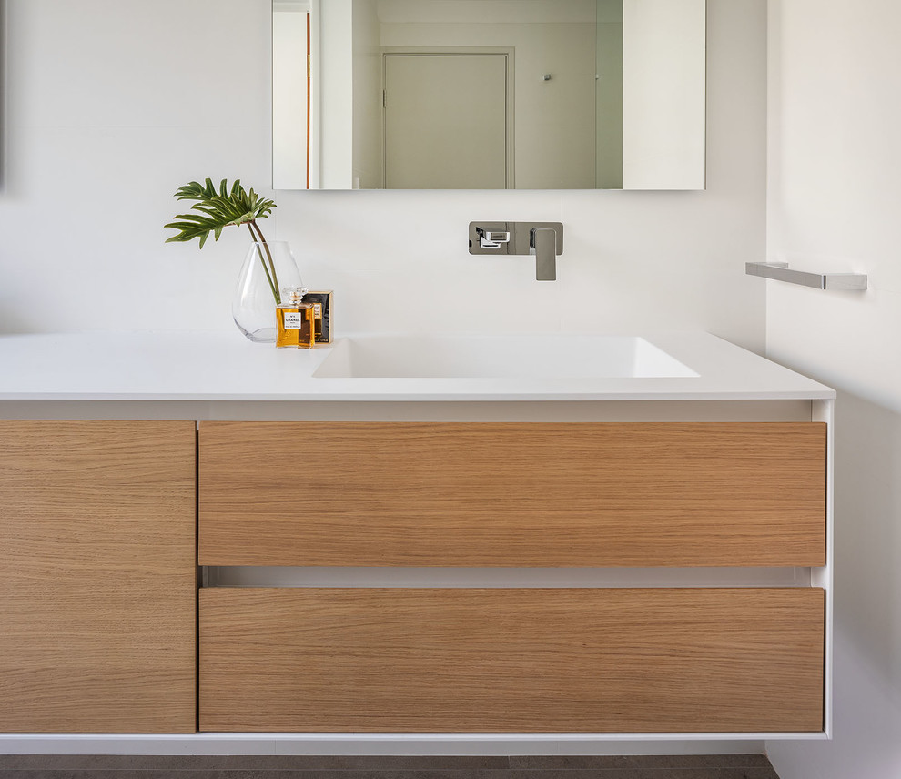 Photo of a mid-sized contemporary master bathroom in Perth with light wood cabinets, white tile, white walls, ceramic floors, an integrated sink, solid surface benchtops, beige floor and a hinged shower door.