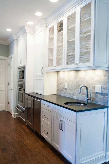 Wyite Cabinets With Chicken Wire Inserts And Granite Countertop