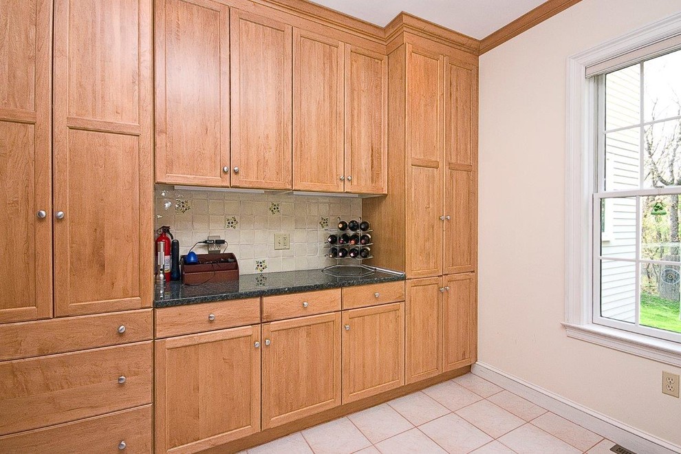 Large traditional dedicated laundry room in Boston with medium wood cabinets, marble benchtops and ceramic floors.