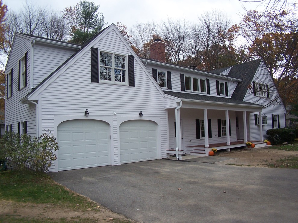 Photo of a large country two-storey white house exterior in Boston with wood siding, a gable roof and a shingle roof.